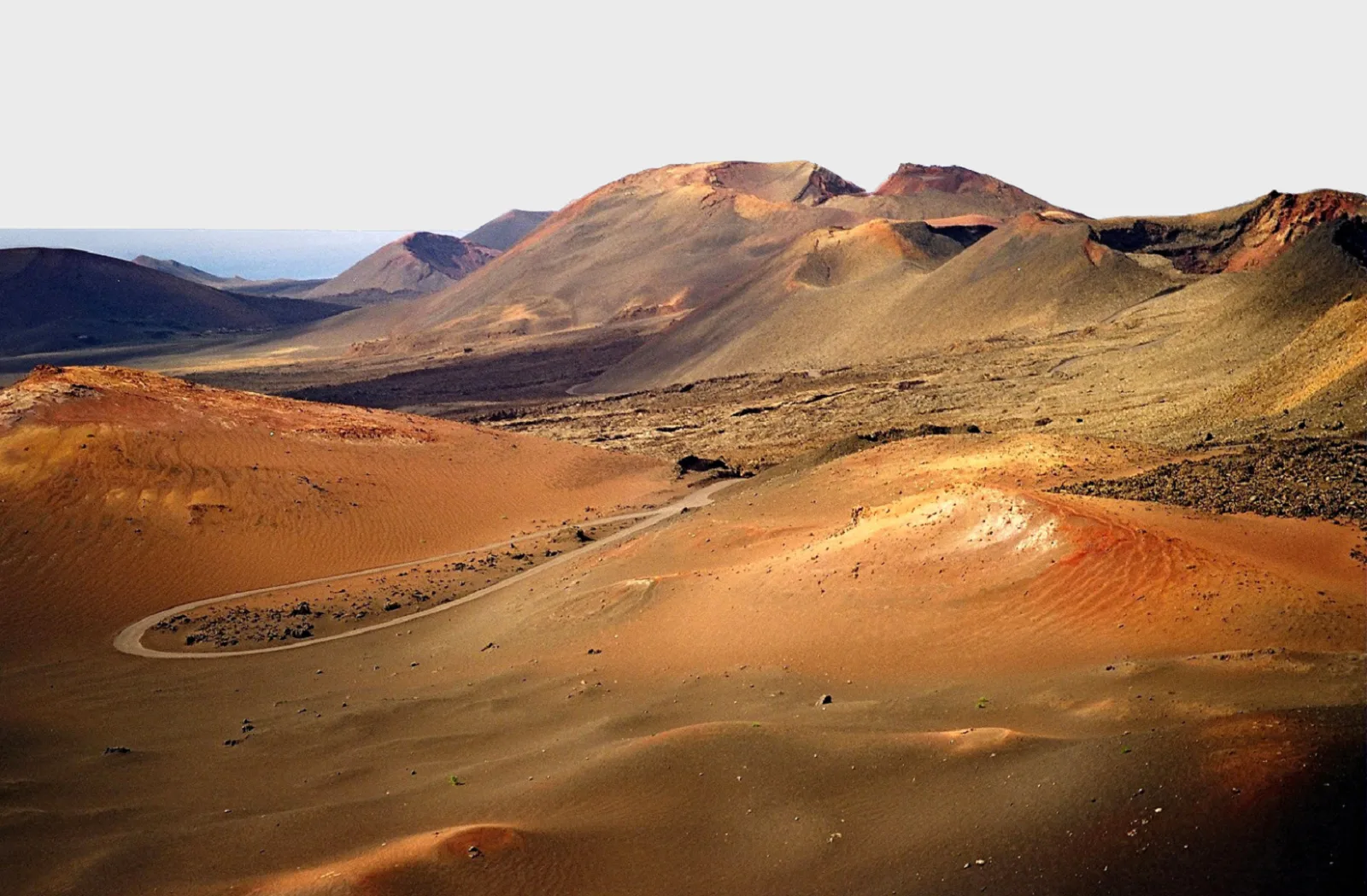 Late sun across the ochre and grey cones of the Timanfaya crater field